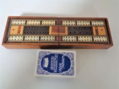 An antique inlaid cribbage board and cards