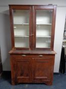 An antique pine glazed door bookcase