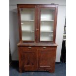 An antique pine glazed door bookcase