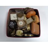 A box containing assorted travel clocks cases and parts