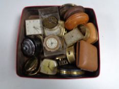 A box containing assorted travel clocks cases and parts