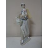 A Lladro figure of a girl with hen