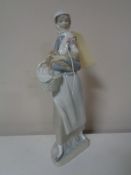 A Lladro figure of a girl with hen