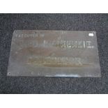 An antique brass Fred J McKenzie solicitor's wall plaque