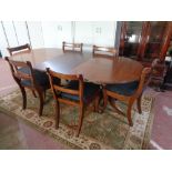 A mahogany brass inlaid twin pedestal dining table with leaf together with six chairs