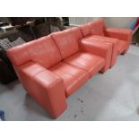 A two seater settee and armchair in salmon pink leather