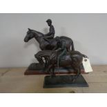 Two resin figures of a horse and jockey