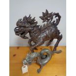 A Chinese metal desiccative dragon and one other figure
