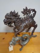 A Chinese metal desiccative dragon and one other figure