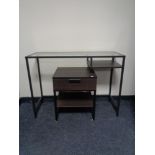 A metal framed glass top dressing table and matching bedside stand