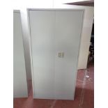 A metal double door stationary cupboard