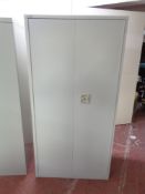A metal double door stationary cupboard