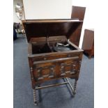 An early 20th century gramophone in oak cabinet by The Minstrel and a box of 78's