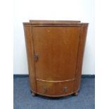 A 20th century bow fronted oak linen chest