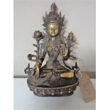 A patinated bronze deity figure in lotus position, with jewelled cabochon decoration,