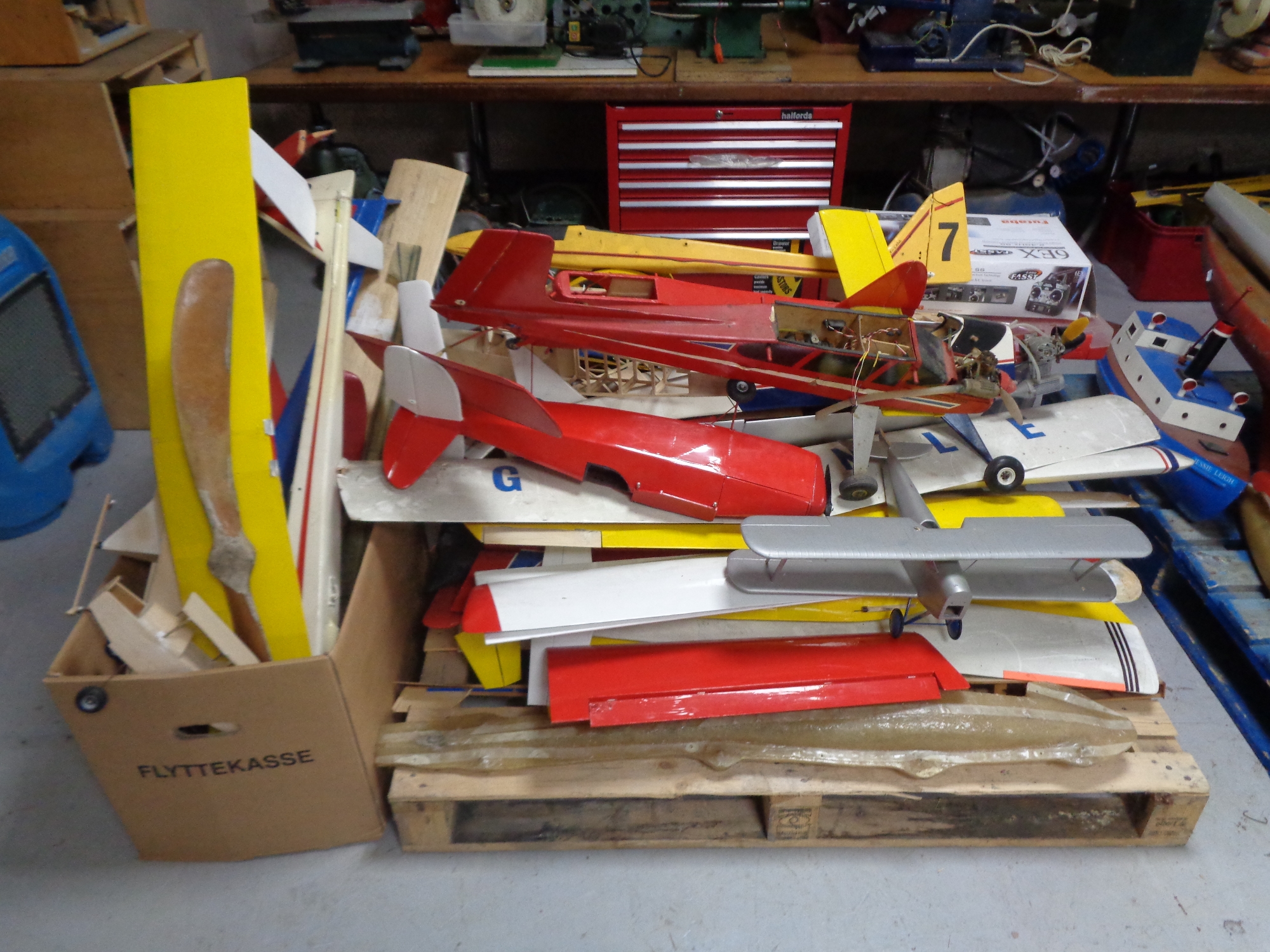 A pallet of remote controlled model planes and accessories including ABA 6EX control hand sets