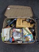 A luggage case containing fishing equipment to include magazines and DVD's, reels,