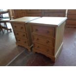 A pair of pine three drawer bedside chests