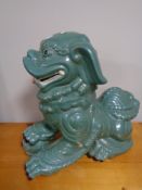 A large ceramic Temple dog with ball