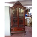 A Victorian style double door display cabinet fitted with drawer beneath