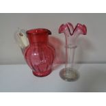 A Victorian cranberry glass water jug together with an antique two-tone glass crimped vase