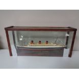 A hand built model of the RMS Queen Mary in display case