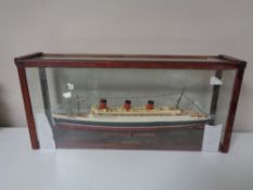 A hand built model of the RMS Queen Mary in display case