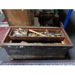 An antique pine joiner's tool chest containing hand tools