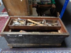 An antique pine joiner's tool chest containing hand tools