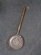 An antique copper bed warming pan