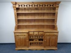 A stripped pine inverted breakfront kitchen dresser CONDITION REPORT: 184cm wide by