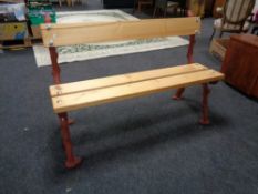 A cast iron bench with reclaimed pine seat and back