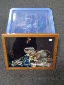 A plastic tub and a counter top display cabinet containing a quantity of assorted costume jewellery