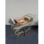 A mid century Coach built doll's pram together with a dolls cot and two dolls