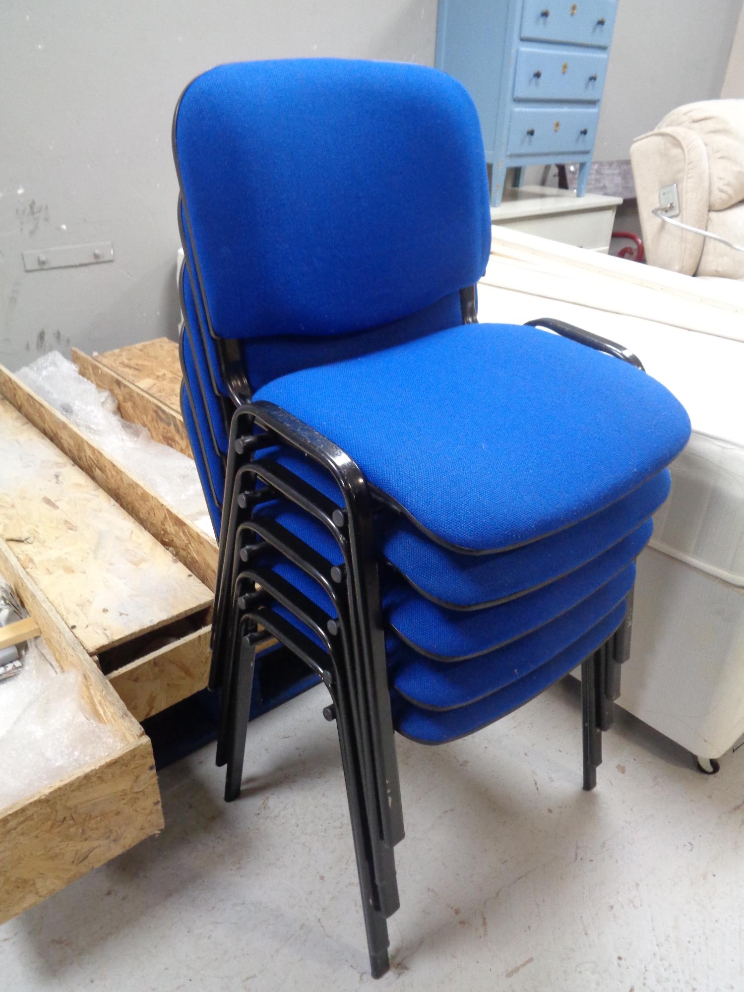 Five metal framed stacking office chairs