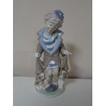 A Lladro figure of a clown with dog and puppies
