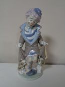 A Lladro figure of a clown with dog and puppies