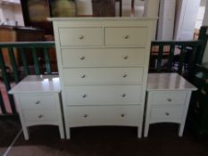 A contemporary white six drawer chest together with a pair of matching two drawer bedside stands