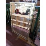A silvered framed bevelled sectional mirror
