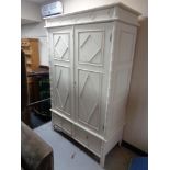A pine double door wardrobe fitted two drawers beneath