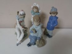 Four Nao figures to include girl in winter dress, boy with rabbit,