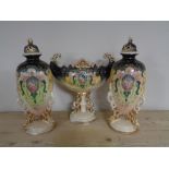 An antique three piece vase garniture on stand