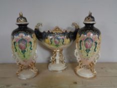 An antique three piece vase garniture on stand