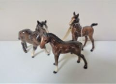 Three small Beswick foal figures.