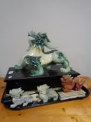 A carved Chinese resin figure of a dragon and three other figures