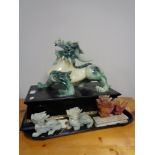 A carved Chinese resin figure of a dragon and three other figures