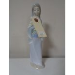 A Lladro figure of a girl with flowers