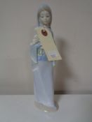 A Lladro figure of a girl with flowers