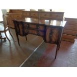 An inlaid mahogany Regency style sideboard on tapered legs