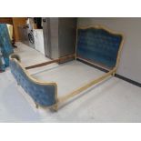 An early 20th century 5' bed frame in blue button dralon
